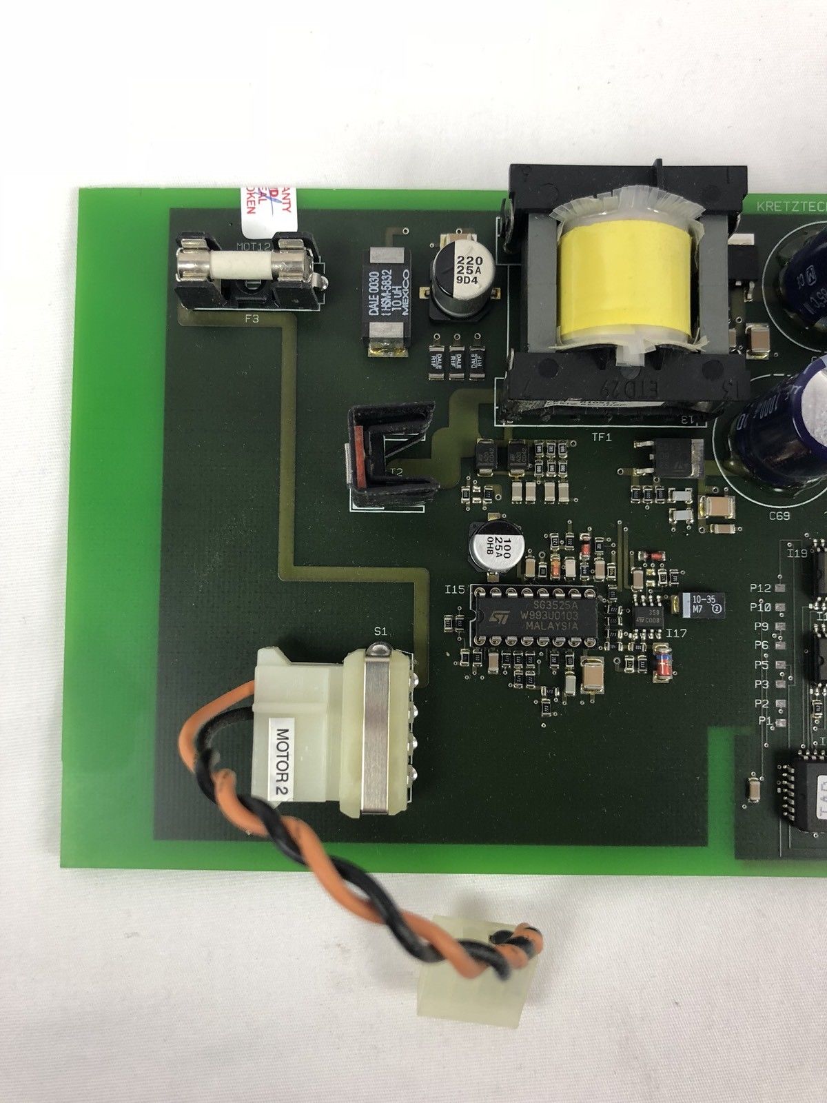 a close up of a circuit board with a yellow light
