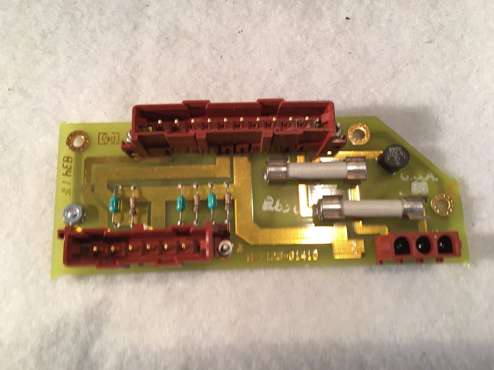 a close up of a circuit board on a white surface