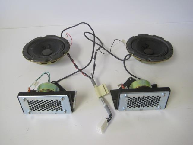 a couple of speakers sitting on top of a table