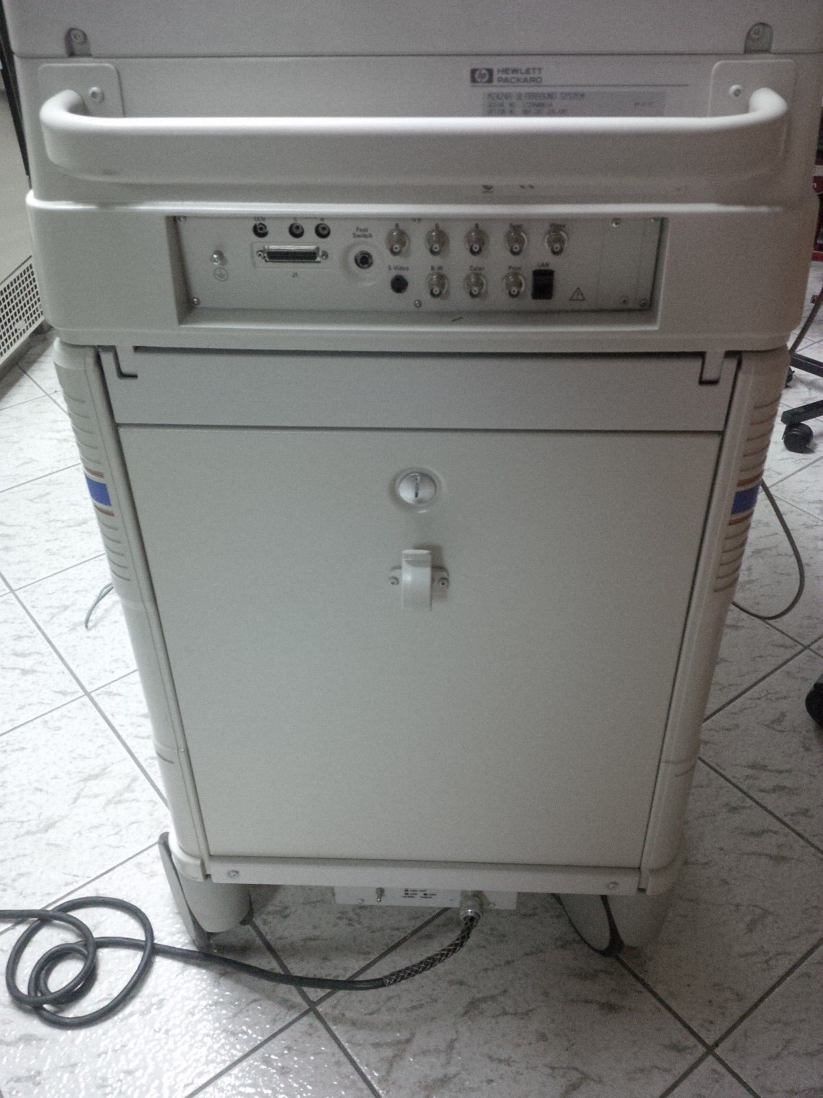 a computer tower sitting on top of a tiled floor