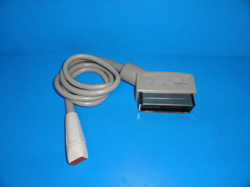 a white cord connected to a gray device on a blue surface
