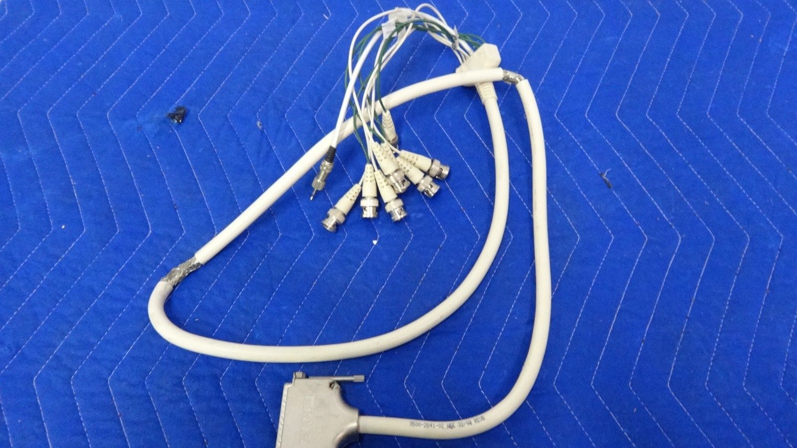a white cord connected to a power cord on a blue surface