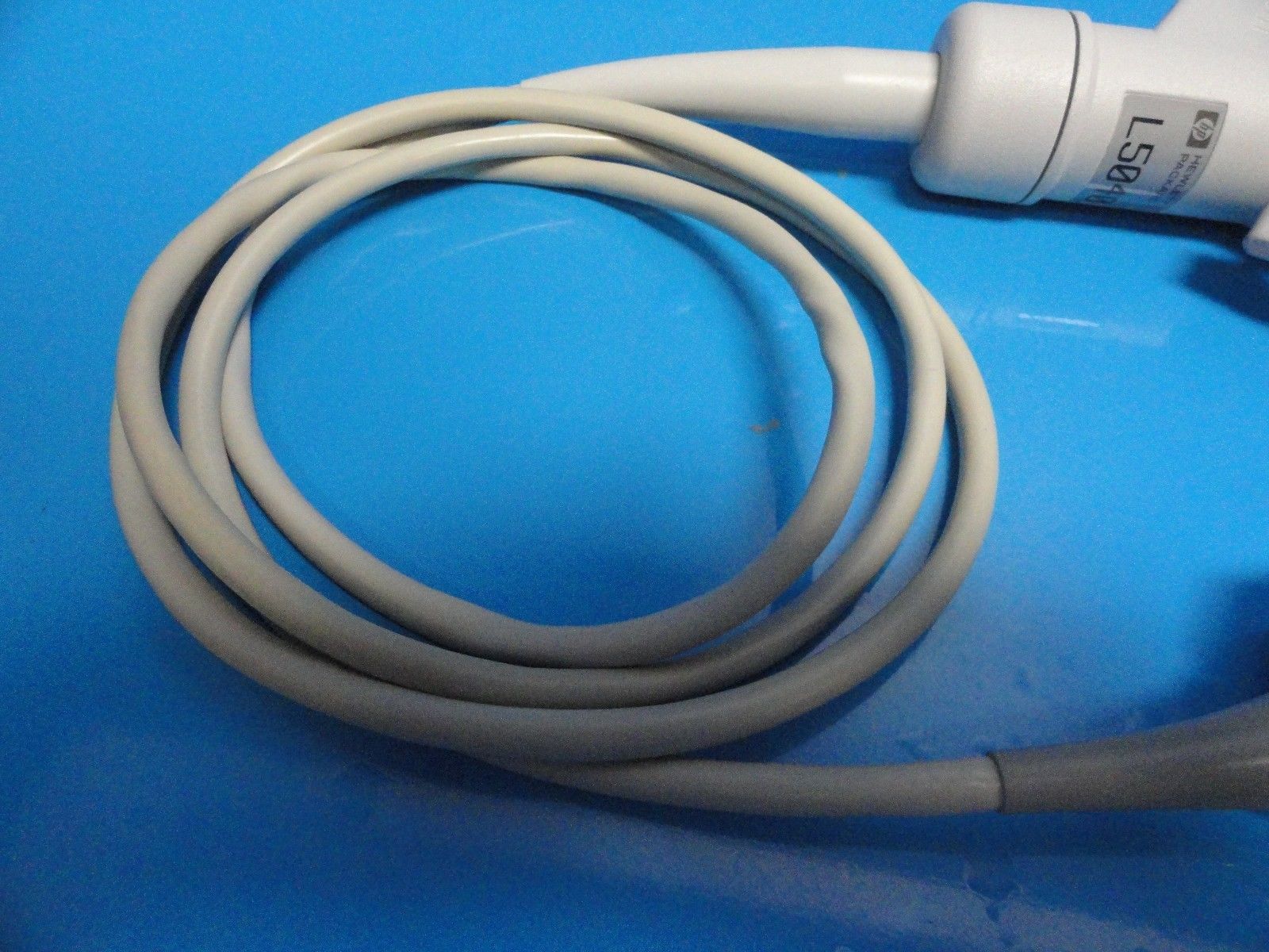 a close up of a white cord connected to a probe heas