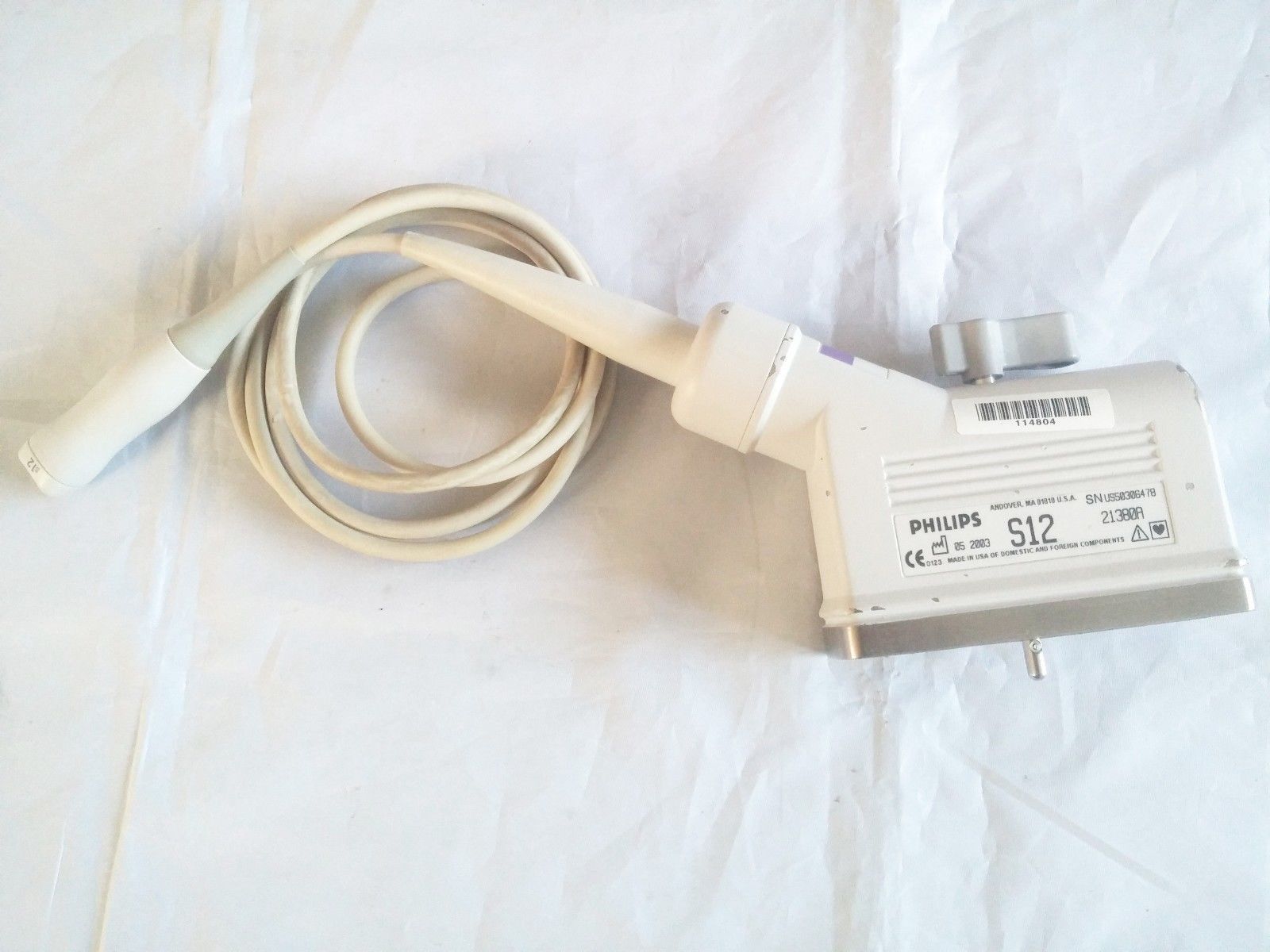 a white cord connected to a device on a white sheet