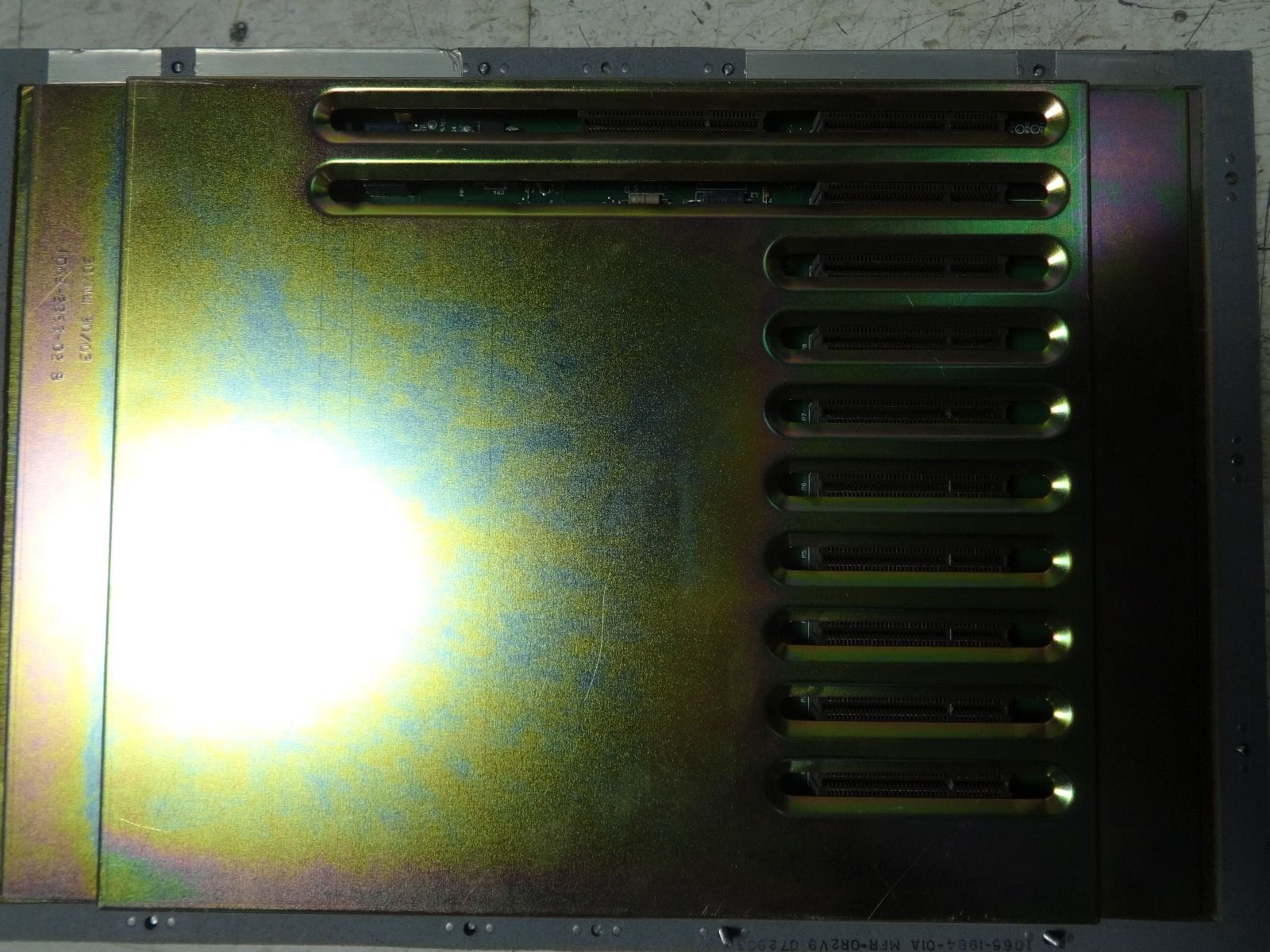 a close up of a metal plate with a light shining through it