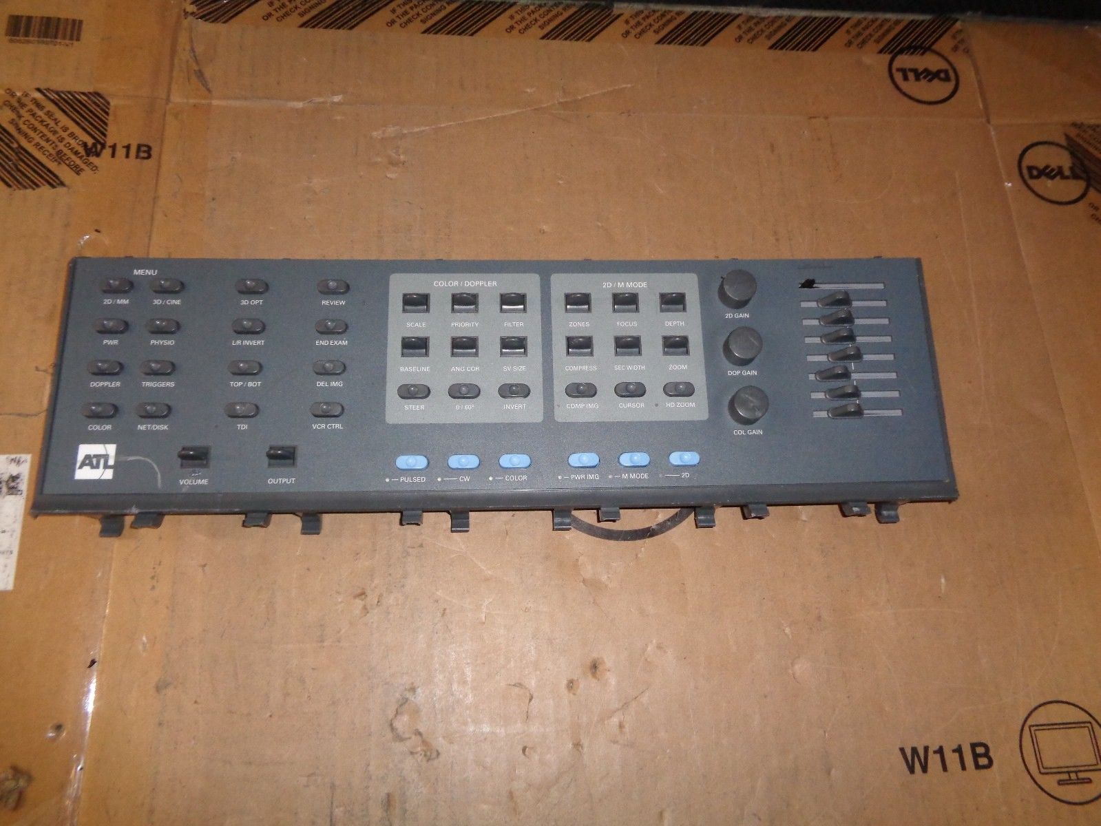 a remote control panel sitting on top of a cardboard box