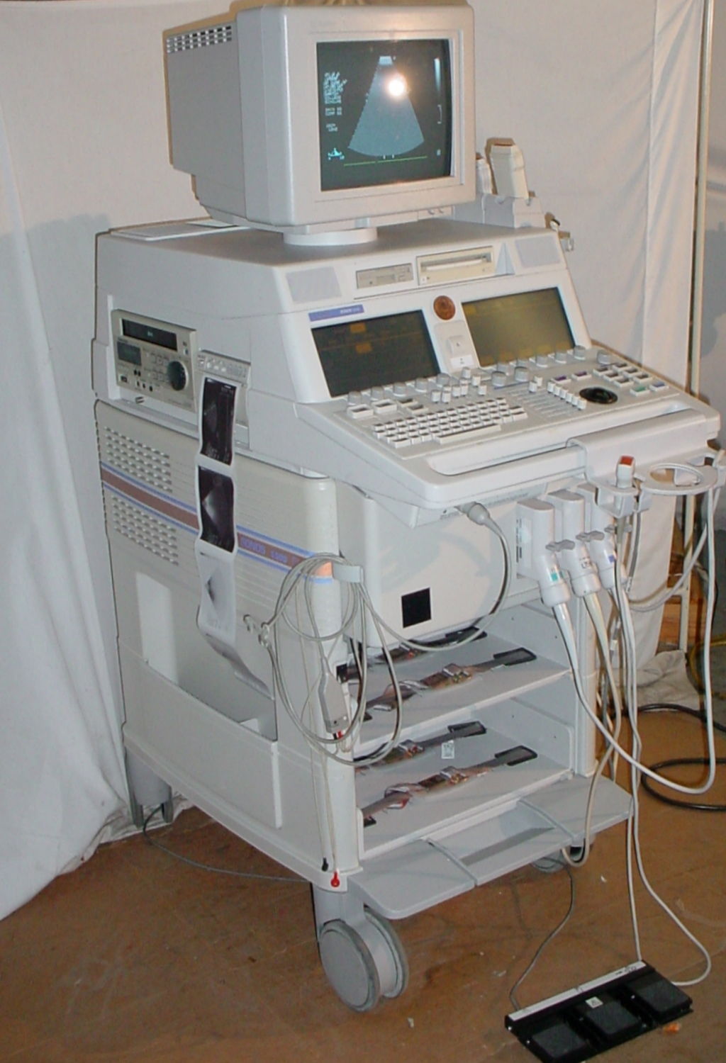 a medical machine with a laptop on top of it