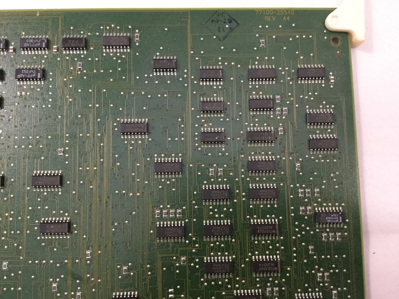 a close up of a circuit board on a white surface