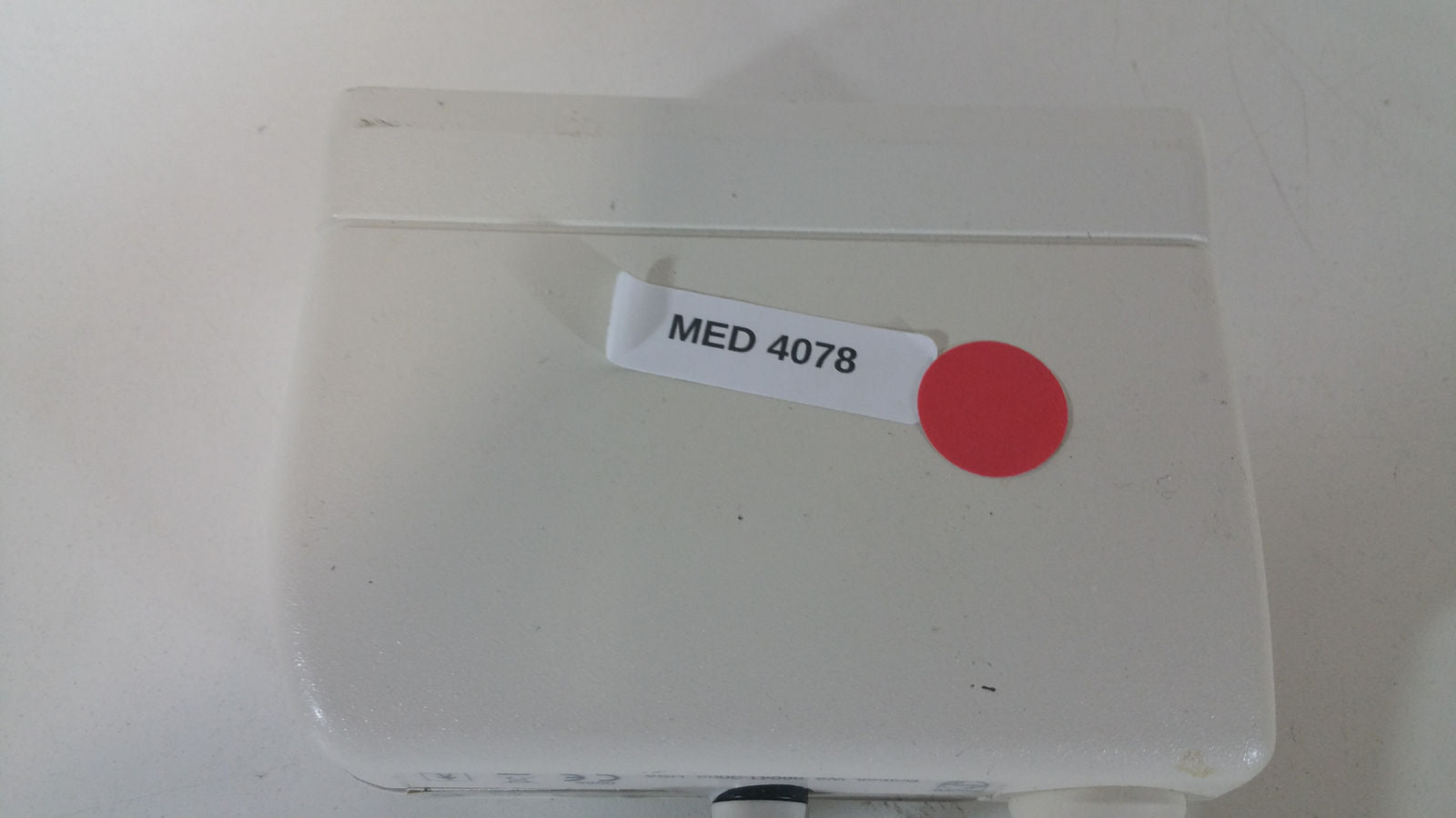 a medical device with a red dot on it