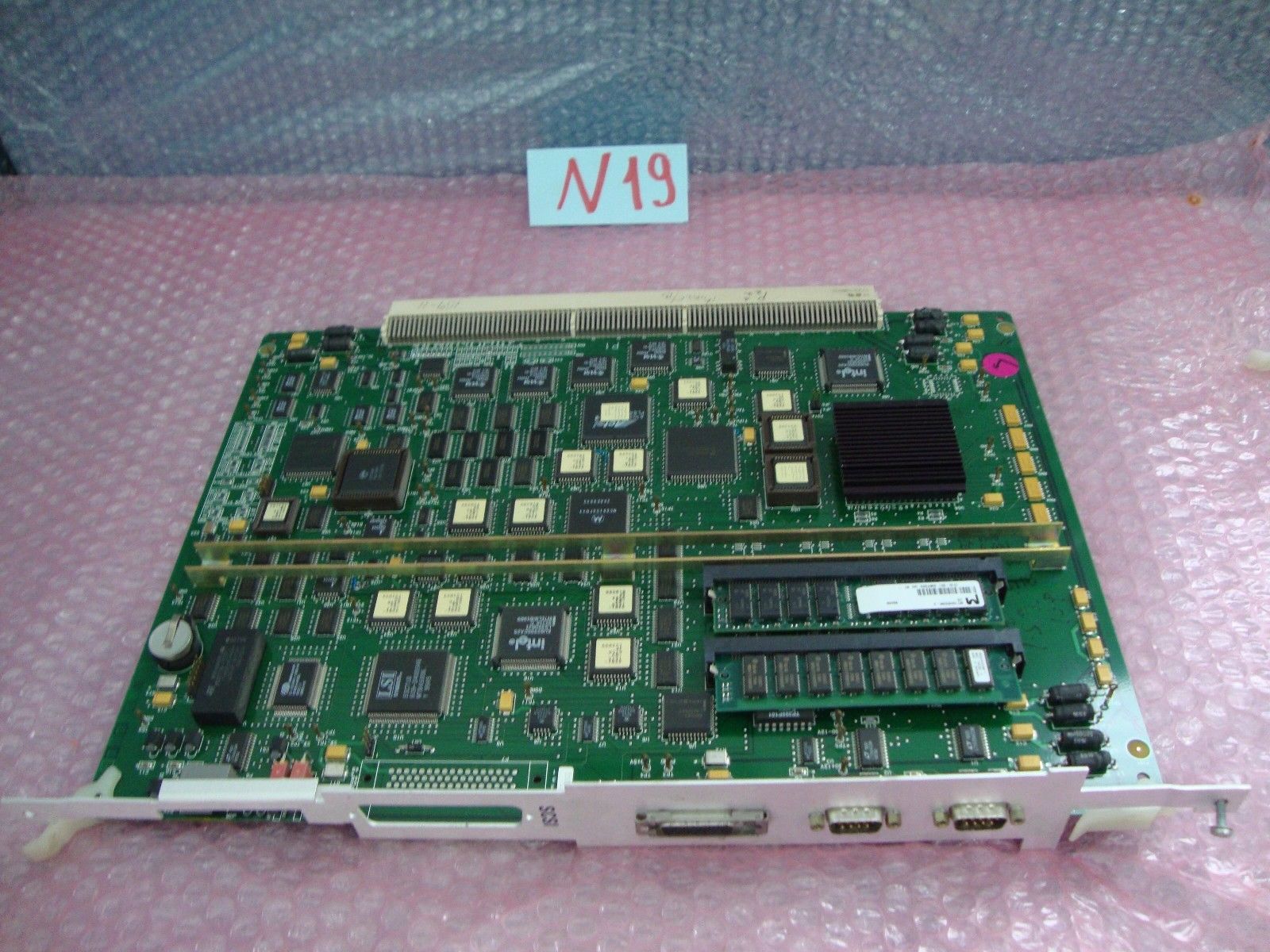 green motherboard on pink table